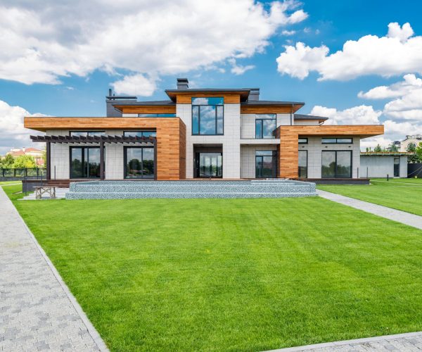Stunning modern house exterior showcasing spacious lawn and contemporary architecture.
